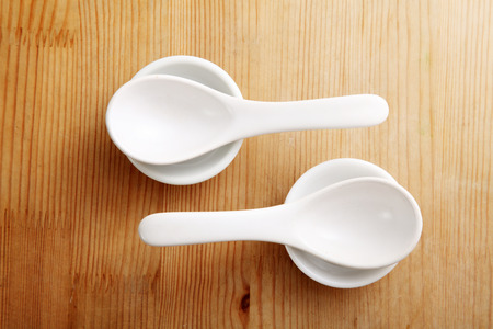 spoon resting on the white saucerの写真素材