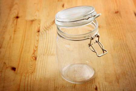opened air tight glass jar on the wooden backgroundの写真素材