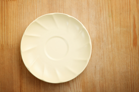 top view of plate or saucer on the wooden backgroundの写真素材