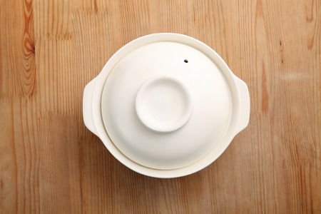 chinese empty clay pot on the wooden backgroundの写真素材