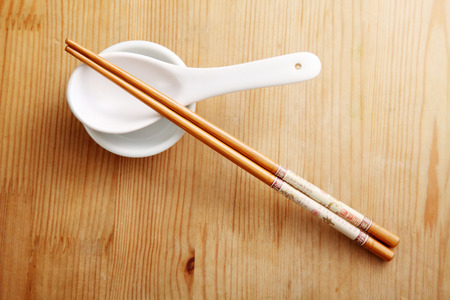 chopsticks resting on the spoon and saucerの写真素材