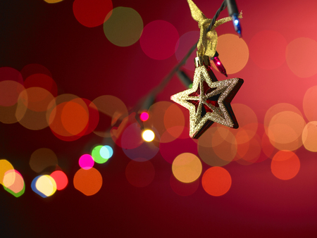 star ornament in front of the sparkle lightsの写真素材