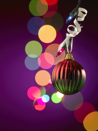beautiful golden christmas balls on a bokeh backgroundの写真素材