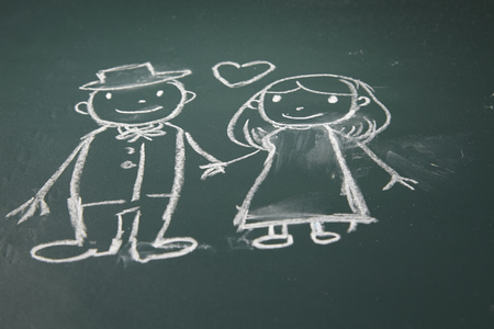 drawing on the chalkboard husband and wife in loveの写真素材