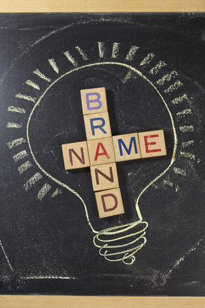 Brand Name Crossword with wooden block on the blackboardの写真素材