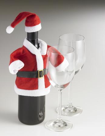 red wine bottle wearing santa claus costumeの写真素材