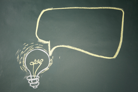 drawing- light bulb on blackboard with speech bubbleの写真素材