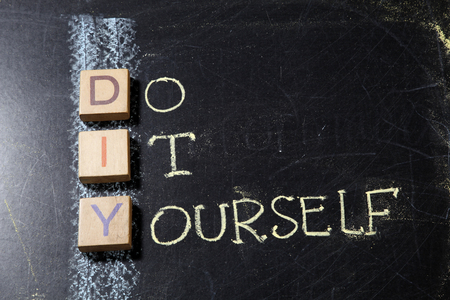 Do It Yourself (DIY), business concept acronym on blackboardの写真素材