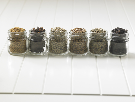 assorted spices in glass containerの写真素材