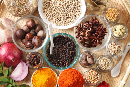 tray of assorted spices on the white wooden table topの写真素材
