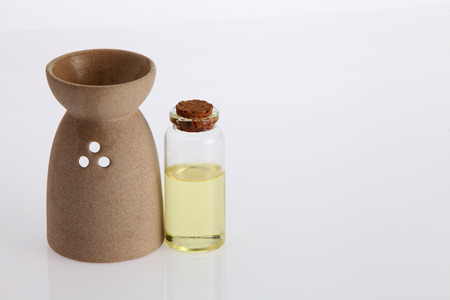 aromatheraphy oil with burner on the white backgroundの写真素材