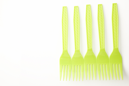 yellow plastic fork on the white backgroundの写真素材
