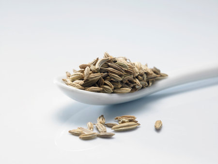 spoon of cumin on the white background