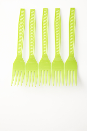 yellow plastic fork on the white backgroundの写真素材