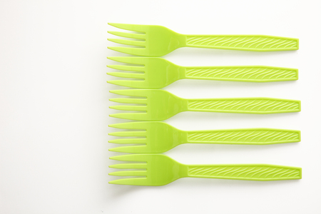 yellow plastic fork on the white backgroundの写真素材