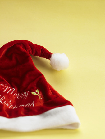 merry christmas hat on the yellow backgroundの写真素材