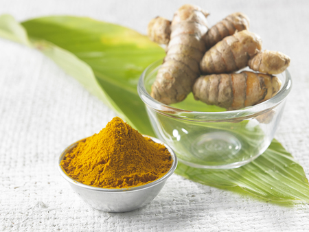 turmeric,powder  and leaf on the wooden backgroundの写真素材