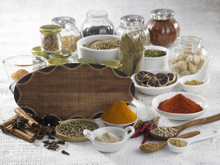 blank wooden board on the assorted spicesの写真素材