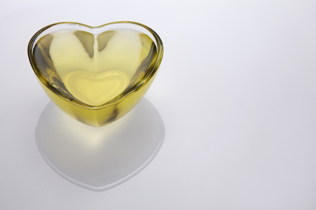 Pouring vegetable cooking oil into a clear glass bowlの写真素材