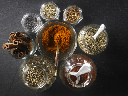 top view of assorted spices on the black slateの写真素材