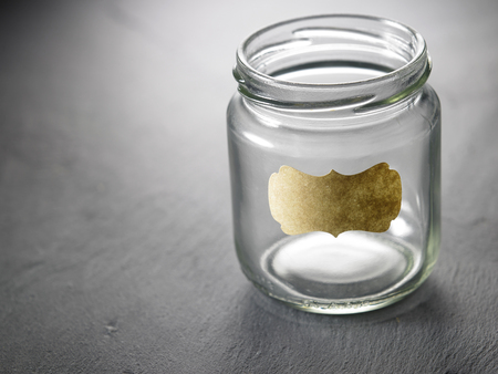 empty saving jar on the black slate labelledの写真素材