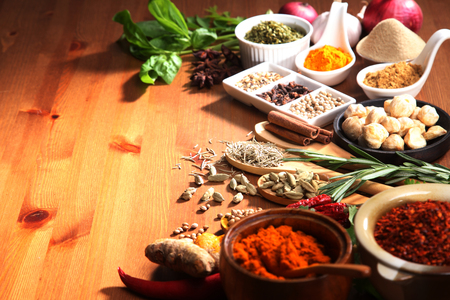 assorted spices and herb on the wooden tableの写真素材