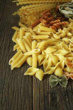 dry pasta on the wooden tableの写真素材