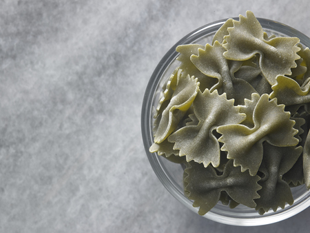 dry farfalloni pasta on the marble topの写真素材