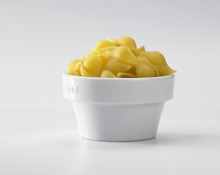 conchiglie rigate on the white backgroundの写真素材