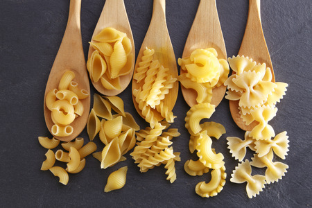 Variety of types and shapes of Italian pasta. Dry pasta backgroundの写真素材