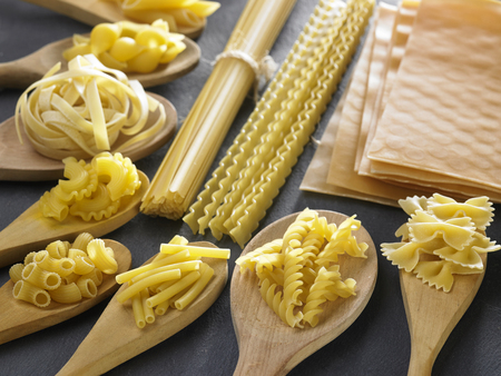 Variety of types and shapes of Italian pasta. Dry pasta backgroundの写真素材