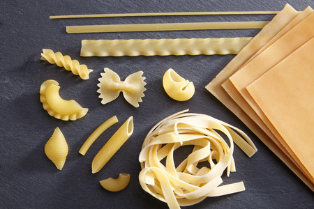 Variety of types and shapes of Italian pasta. Dry pasta backgroundの写真素材