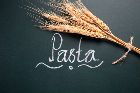 text pasta and wheat straw on the blackboardの写真素材