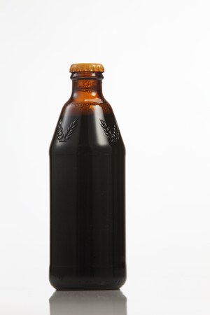 Dark beer in a bottle, isolated on a white backgroundの写真素材