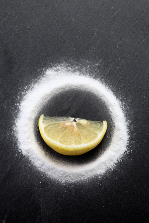 slice of lemon in the middle of baking soda powderの写真素材