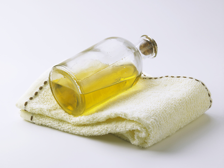 massage oil and towel on the white backgroundの写真素材