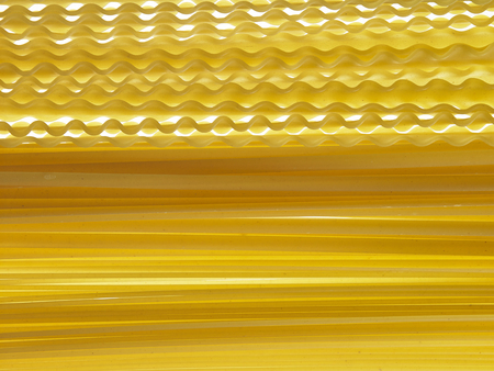 malfaldine and fettuccine and spaghetti dry pasta as backgroundの写真素材