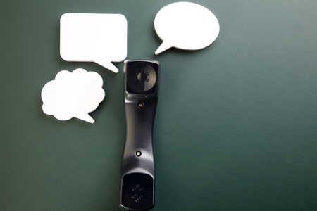 handset with speech bubble on the blackboardの写真素材
