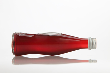 bottle of the blacck currant drink on the white backgroundの写真素材
