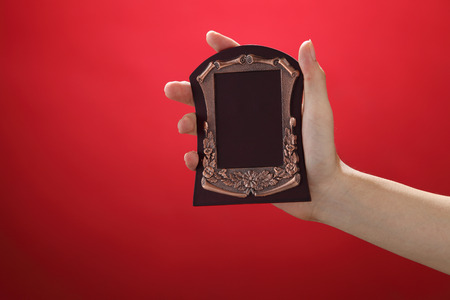 man holding a bronze plate awardの写真素材