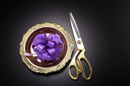 purple round shape ribbon with golden scissors business grand opening conceptの写真素材