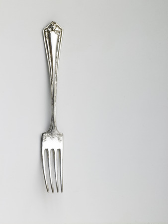 used fork on the white backgroundの写真素材