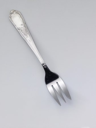 used fork on the white backgroundの写真素材