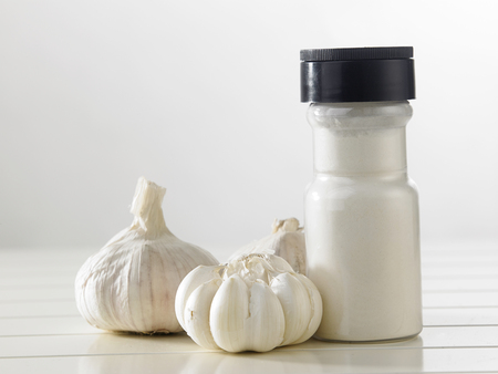 bottle of the garlic powder and garlicの写真素材