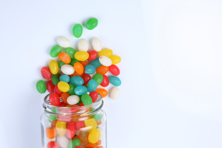 jelly beans pouring out from a jarの写真素材
