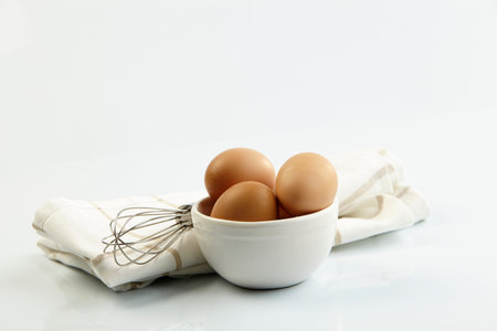 egg in the bowl with wired whisk