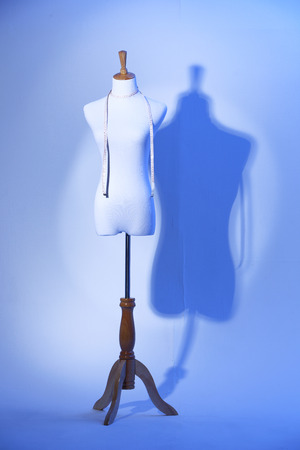 studio shot of female mannequin with measuring tapeの写真素材