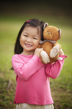 Girl hugging teddy bearの写真素材