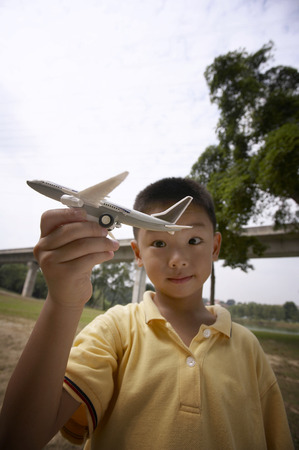 Boy playing with toy airplaneの写真素材