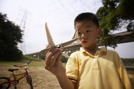Boy playing with toy airplaneの写真素材